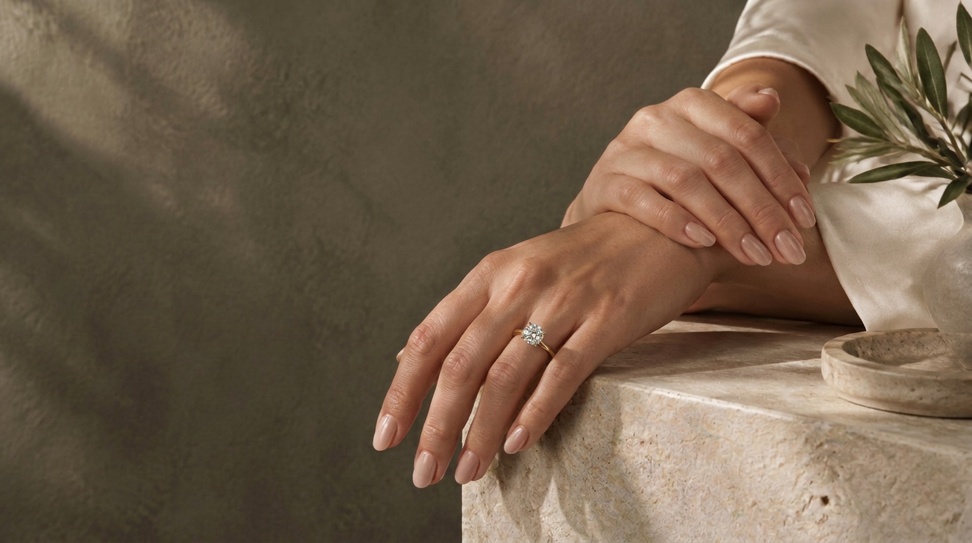 Beautifully polished blush nails with delicate gold jewelry